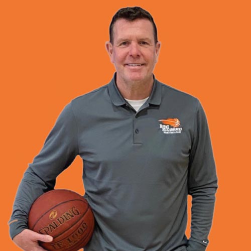 basketball coaching staff holding a mic